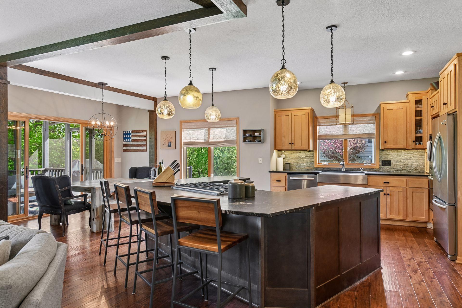 Dreamy kitchen with stainless steel appliances, gorgeous wood floors, and HUGE center island!