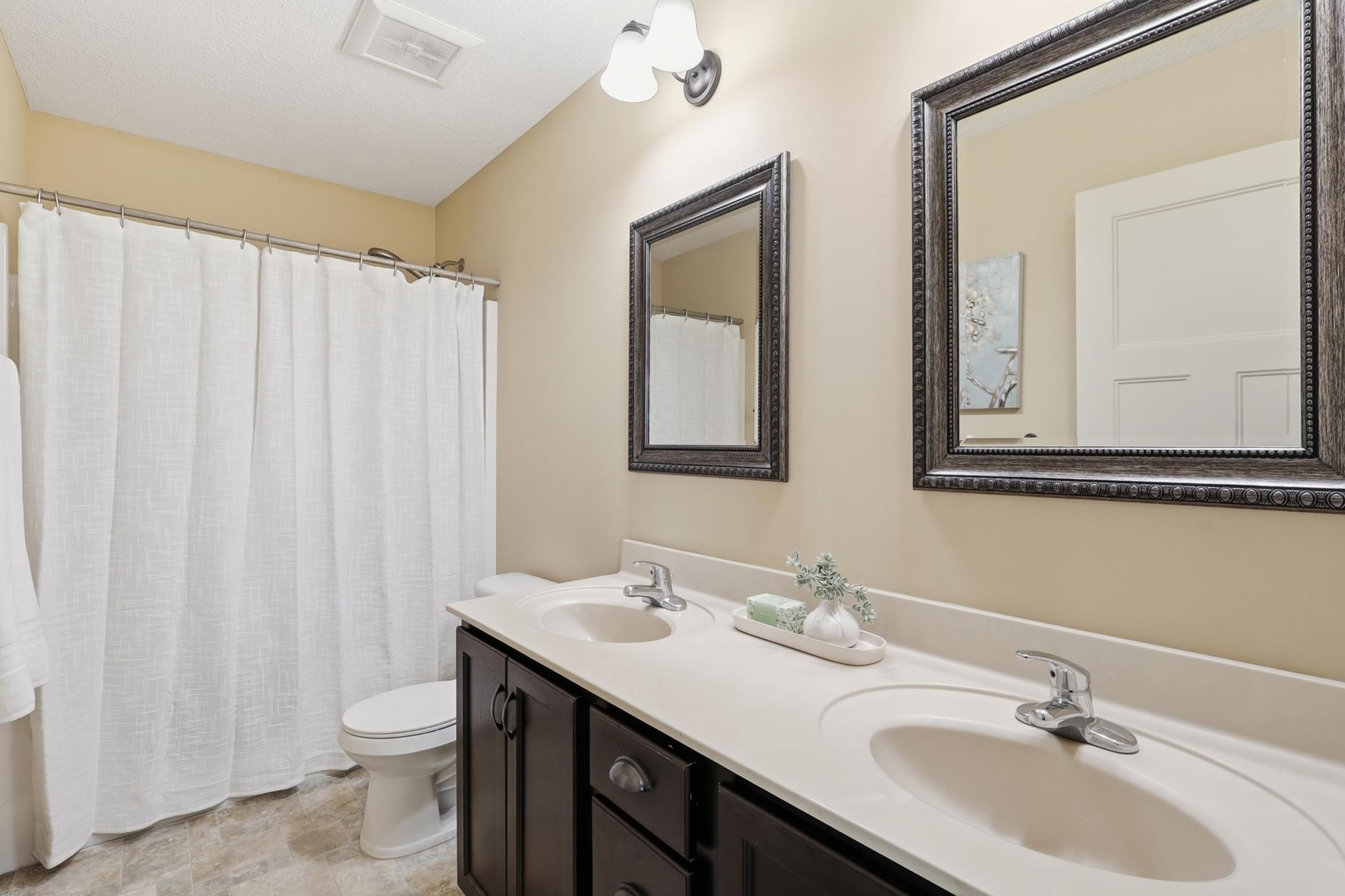 Upper level full bathroom with double sinks