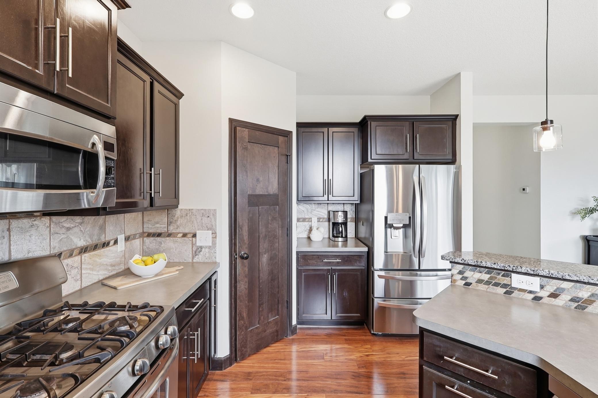 Gleaming stainless appliances & corner pantry