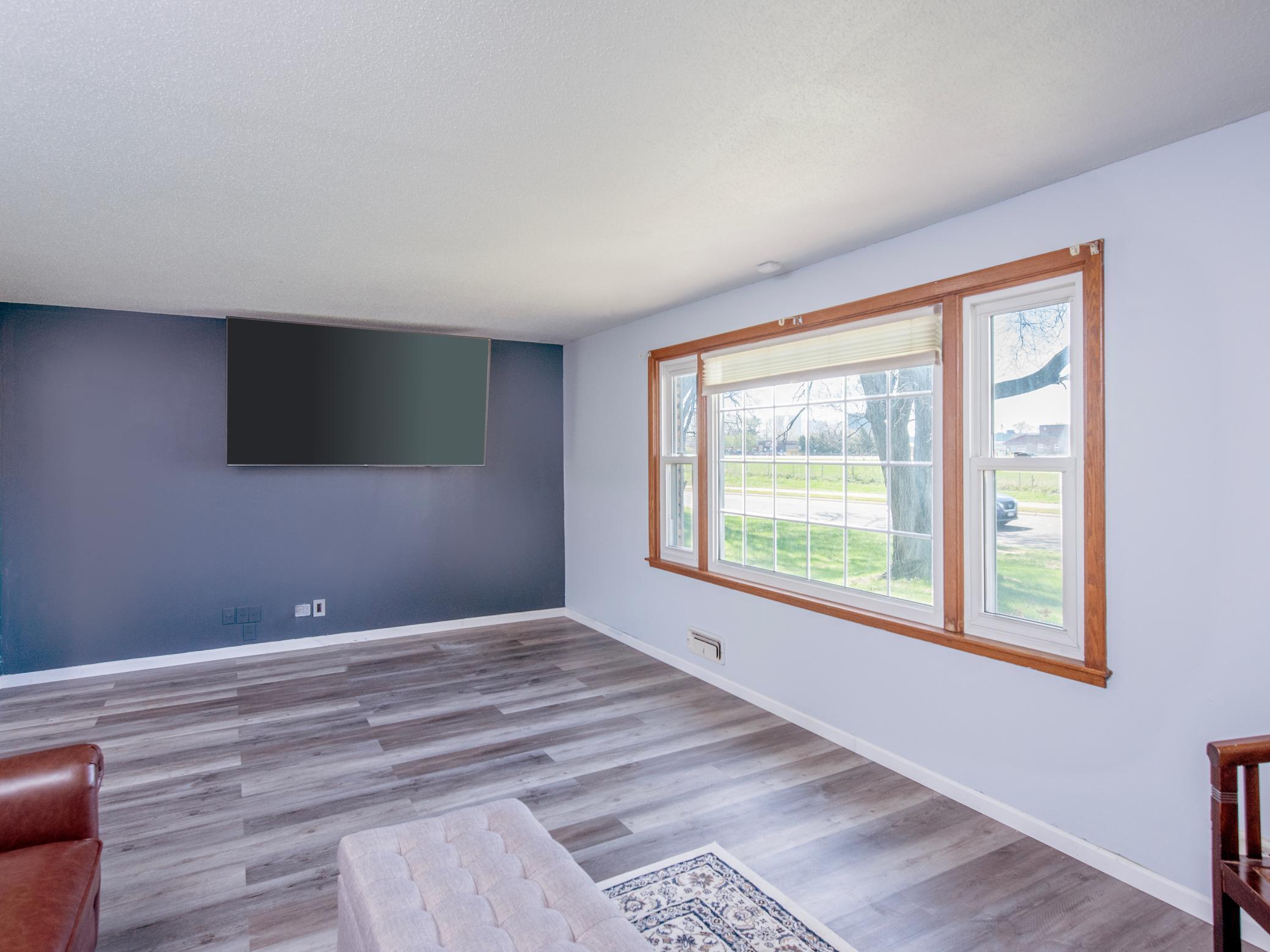 Bright living room has newer flooring and fresh paint!