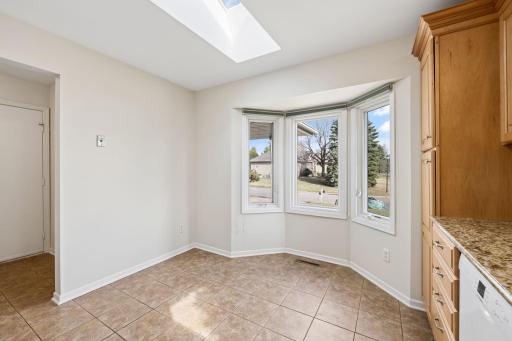The bay window and skylight bring natural light to the kitchen