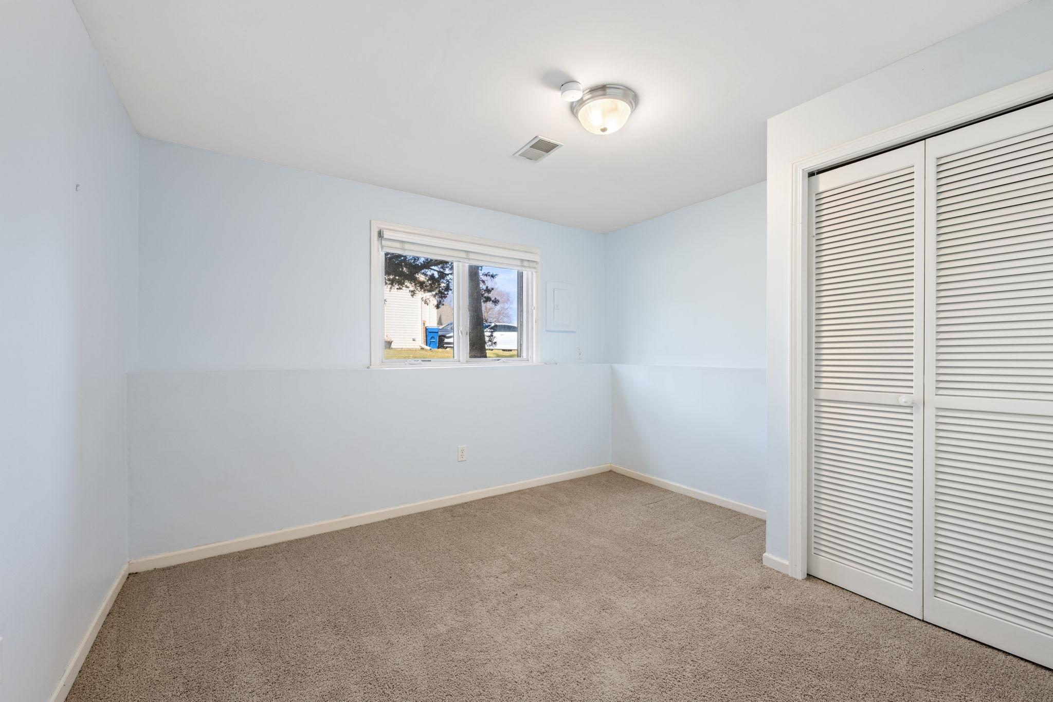 Large lower level bedroom with adjacent bath is the perfect spot for guests.