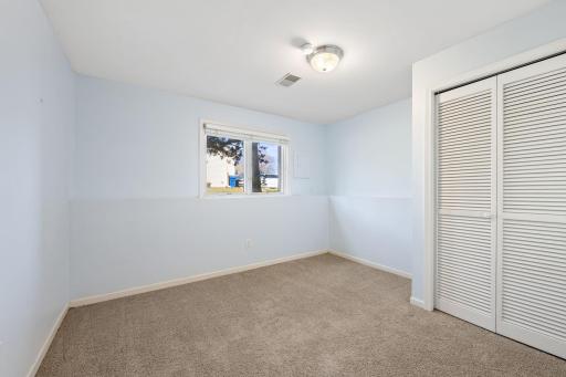 Large lower level bedroom with adjacent bath is the perfect spot for guests.