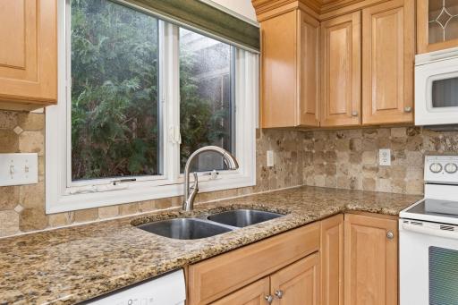 Granite countertops and tile backsplash add a touch of glam.