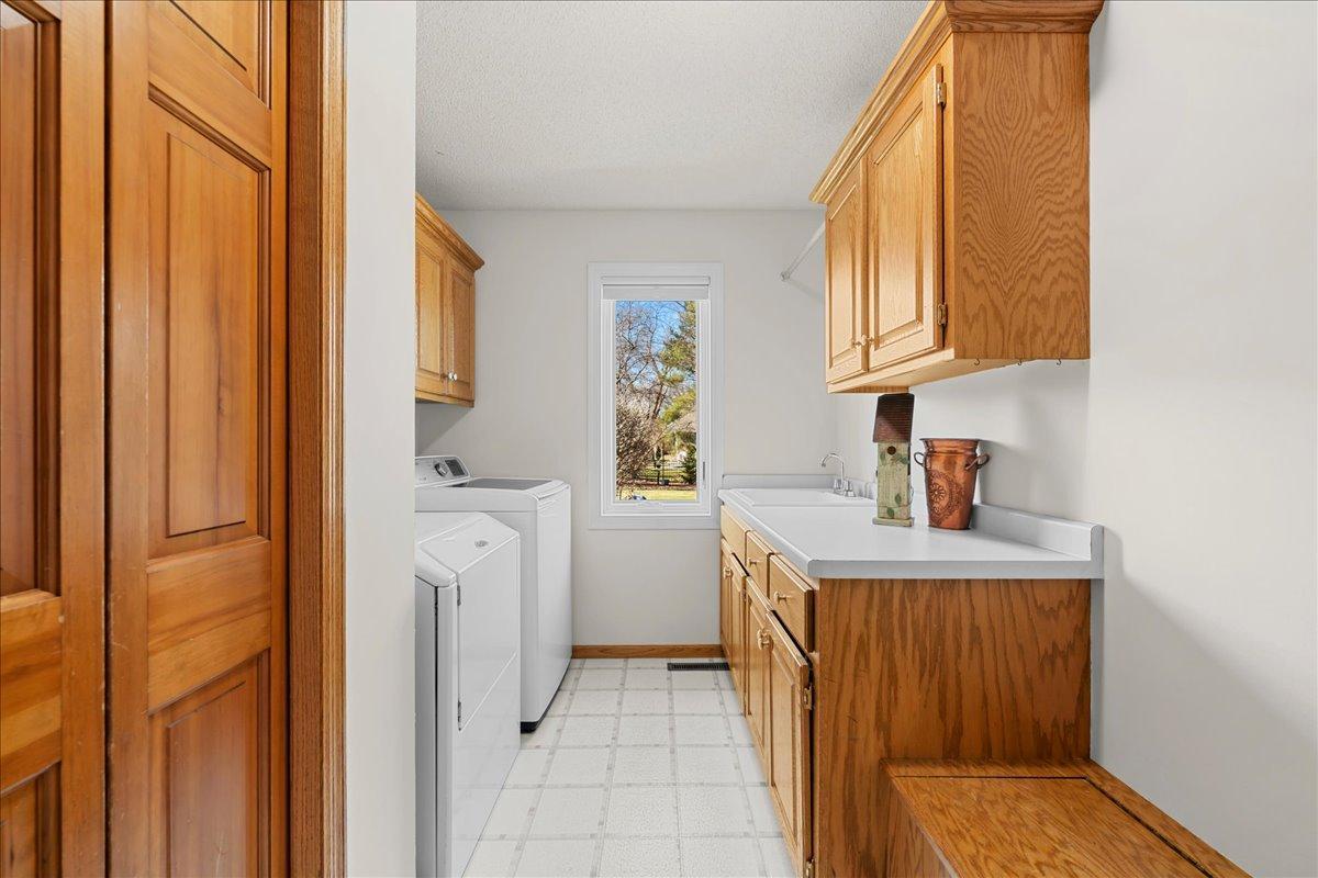 Cabinetry and countertop to help in your laundry chores. Bench for extra storage.