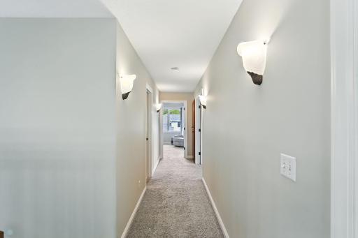 Second level hallway leading into primary suite