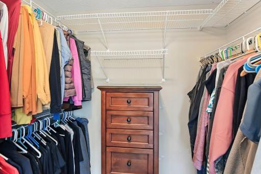 Walk-in closet accessible through primary suite bathroom