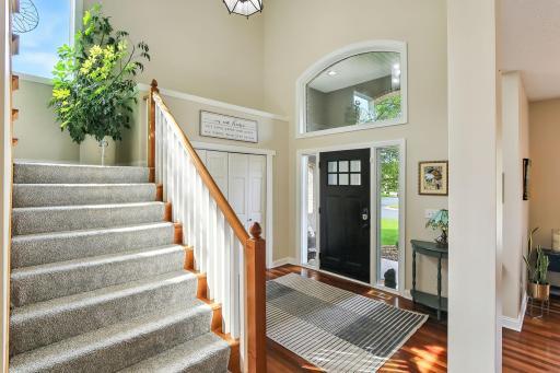 Large windows flood the entry foyer with natural light