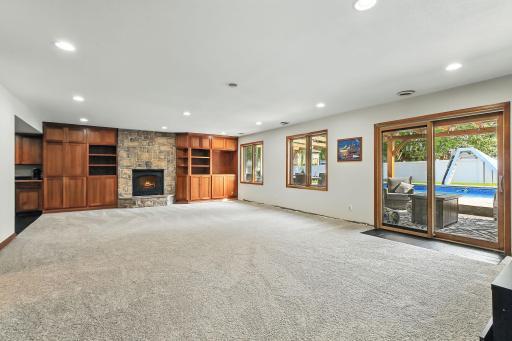 Spacious lower level with fireplace, full kitchenette, and new carpeting in 2025
