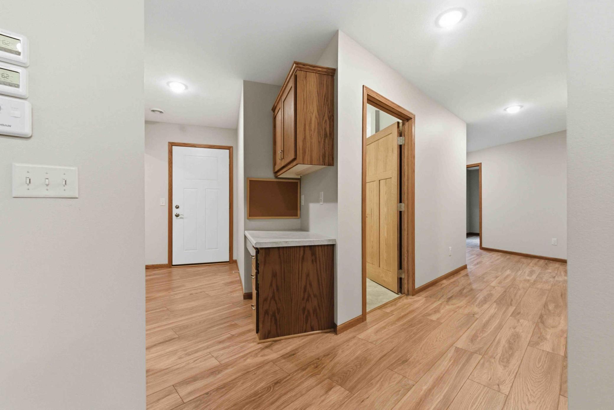 Kitchen towards garage door and hallway towards bedrooms