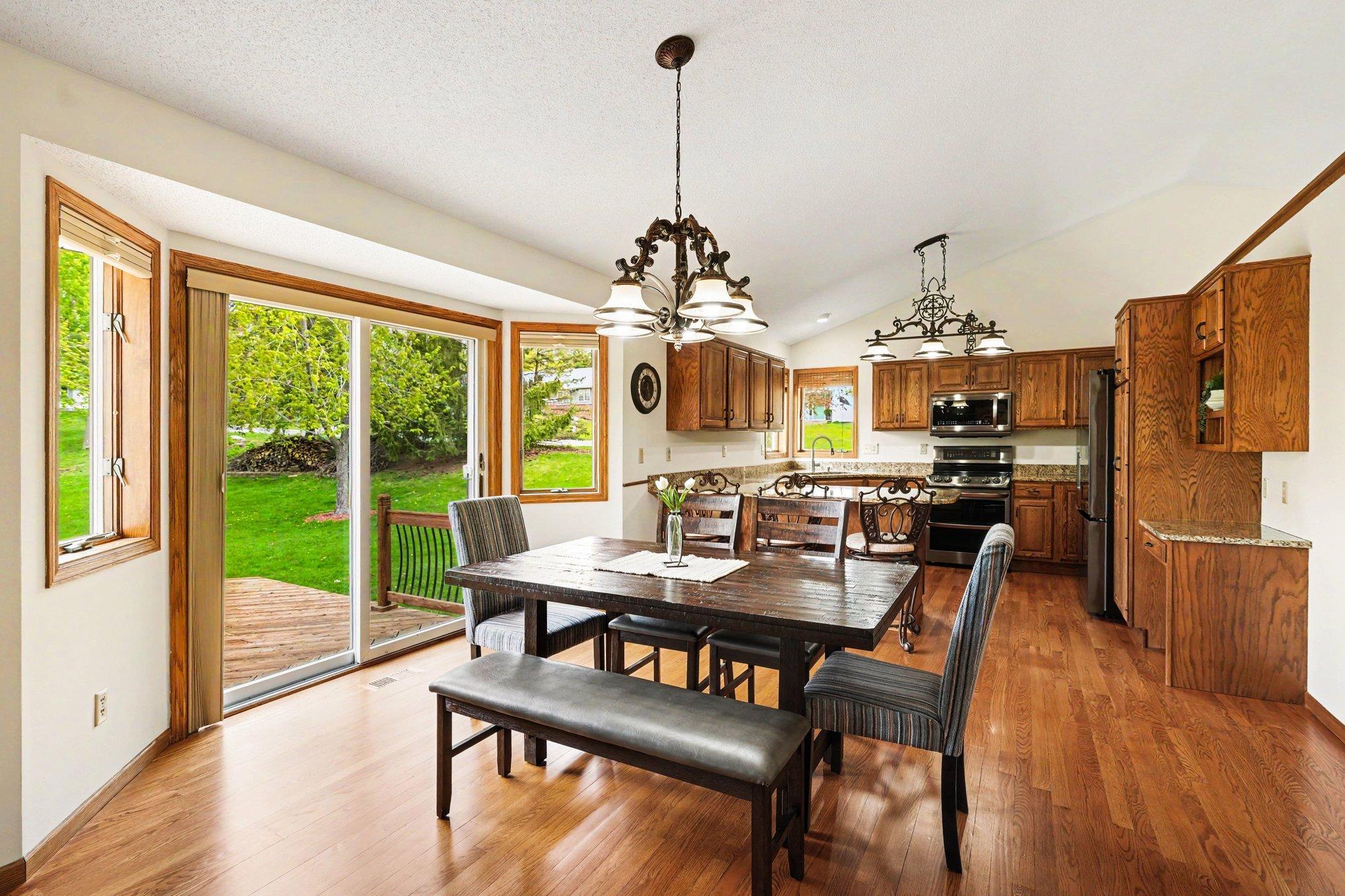 The main level features an open layout that seamlessly connects the kitchen & living area, with a vaulted ceiling. The informal dining room features hardwood floors & a patio door that opens to a large backyard deck—perfect for indoor-outdoor living!