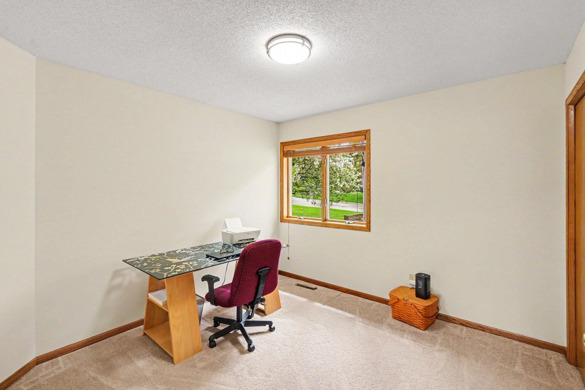 The main level features a versatile den with elegant glass French doors and a roomy closet. This bright, flexible space is perfect for a home office, library, or guest room.