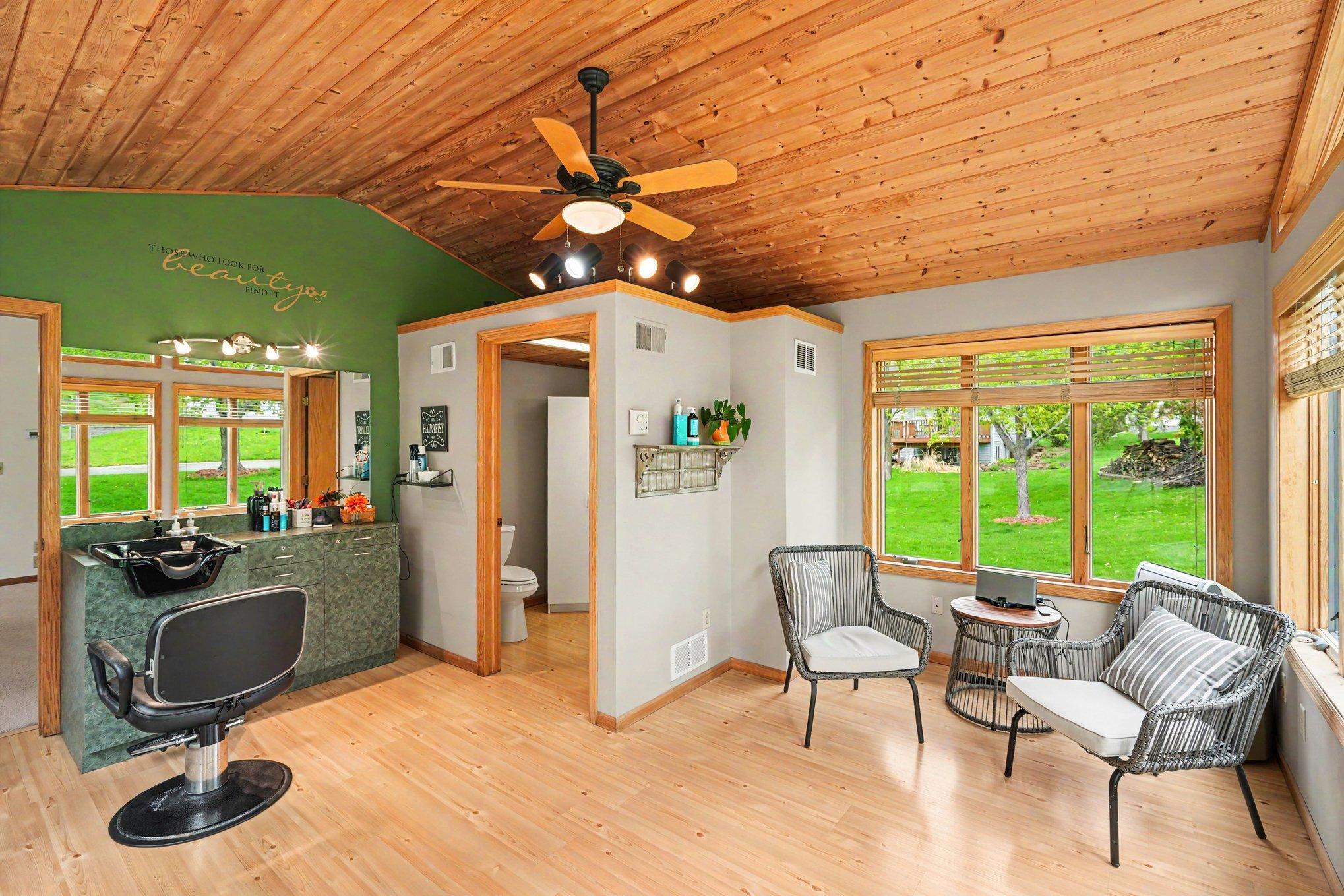Fantastic business opportunity! This 4-season sunroom features a private ADA entrance and currently serves as a hair salon. Highlights include a vaulted knotty pine ceiling, a wall of windows, a ceiling fan, and a private half-bath.