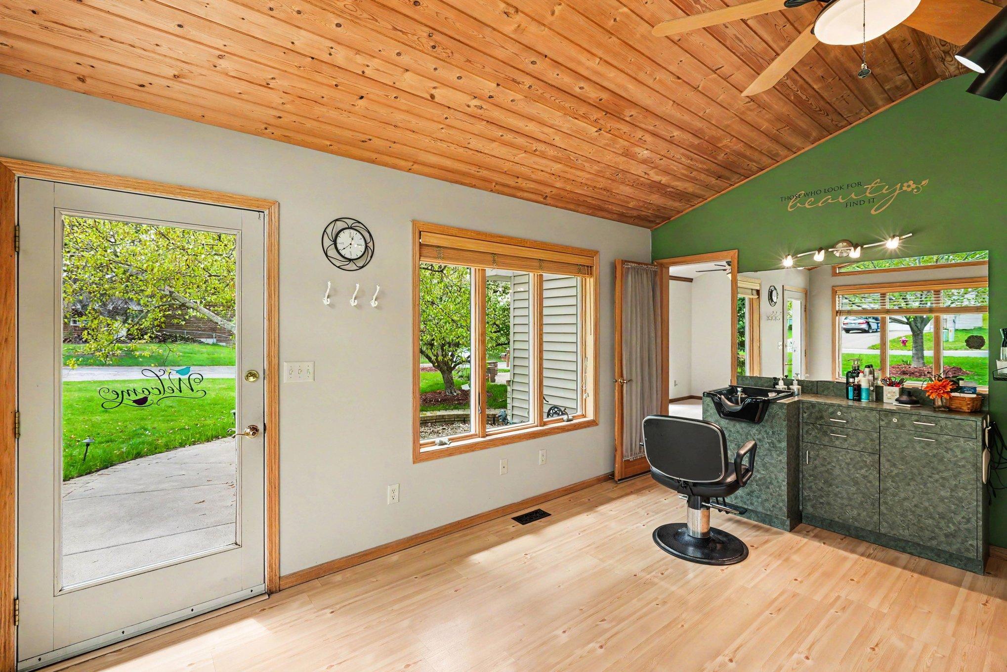 This view highlights the private, ADA-compliant entrance to the four-season sunroom. A sturdy concrete walkway provides easy, step-free access directly to the space—ideal for clients or a private home office.