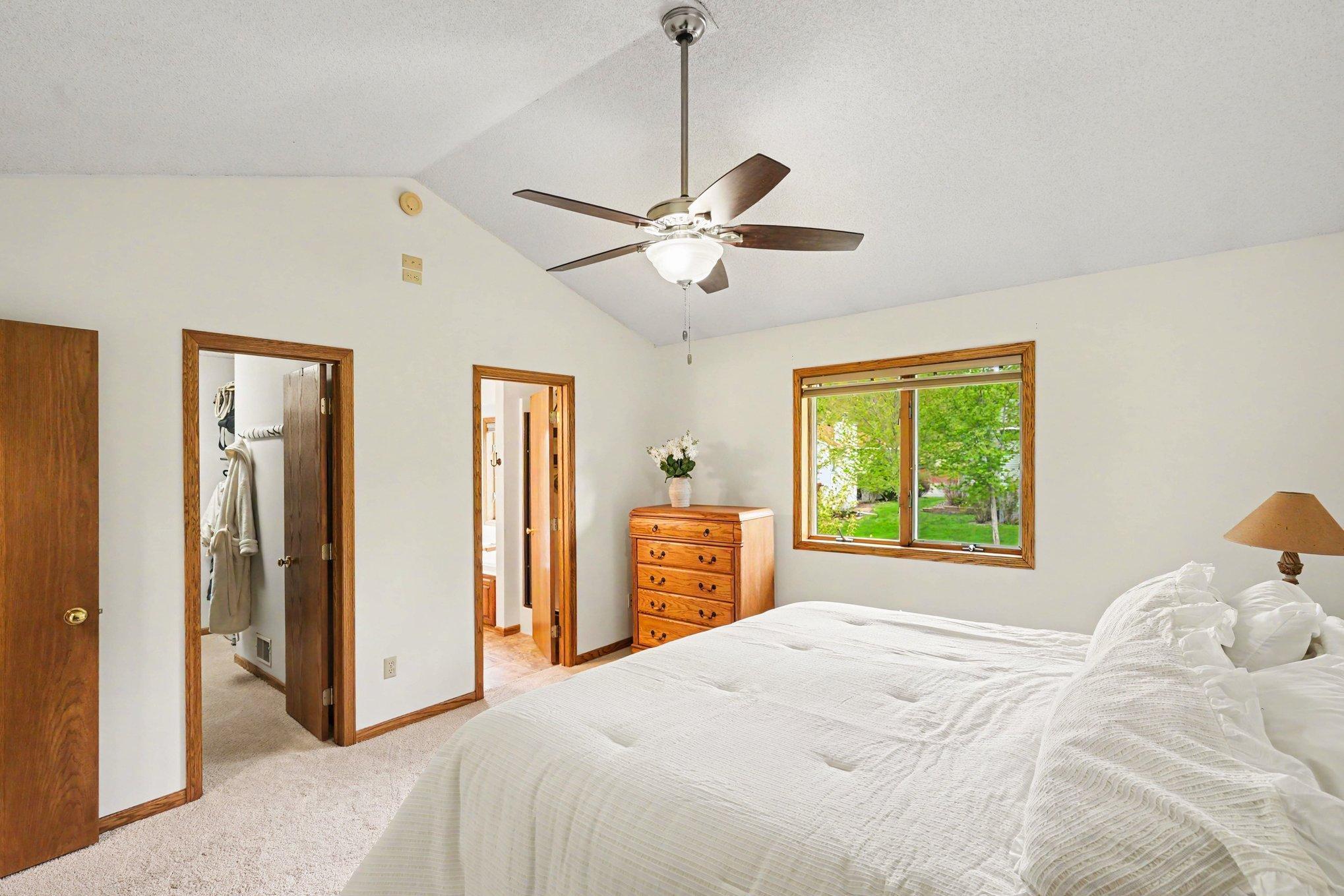 This view of the primary suite highlights the spacious walk-in closet and the entrance to your private full bathroom. A perfectly designed layout for comfort and convenience!