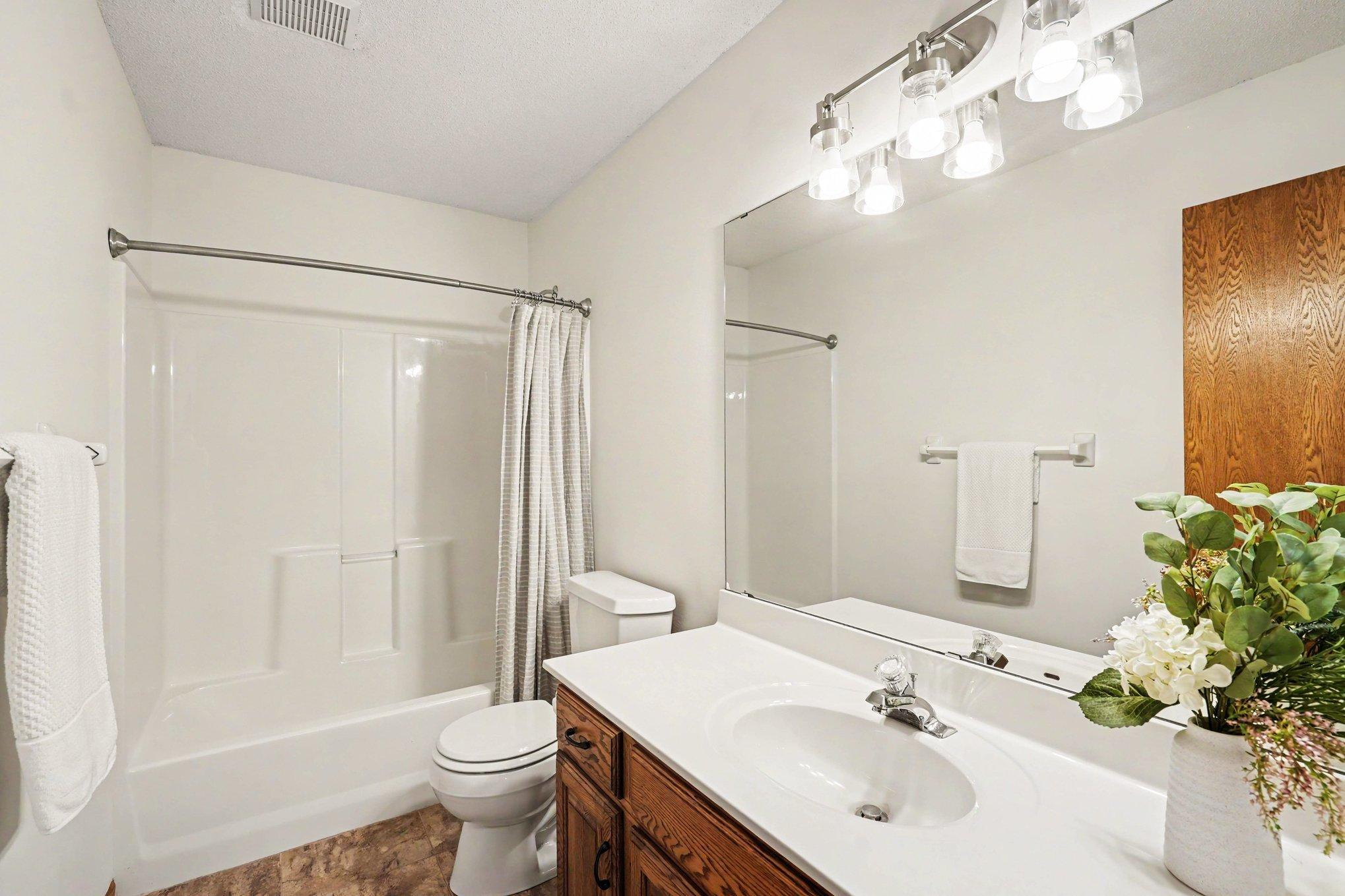 The upper level also includes a full bathroom with luxury vinyl tile floors & a large vanity with storage. There's a deep linen closet just outside in the hallway. A bright, functional space perfect for family or guests!