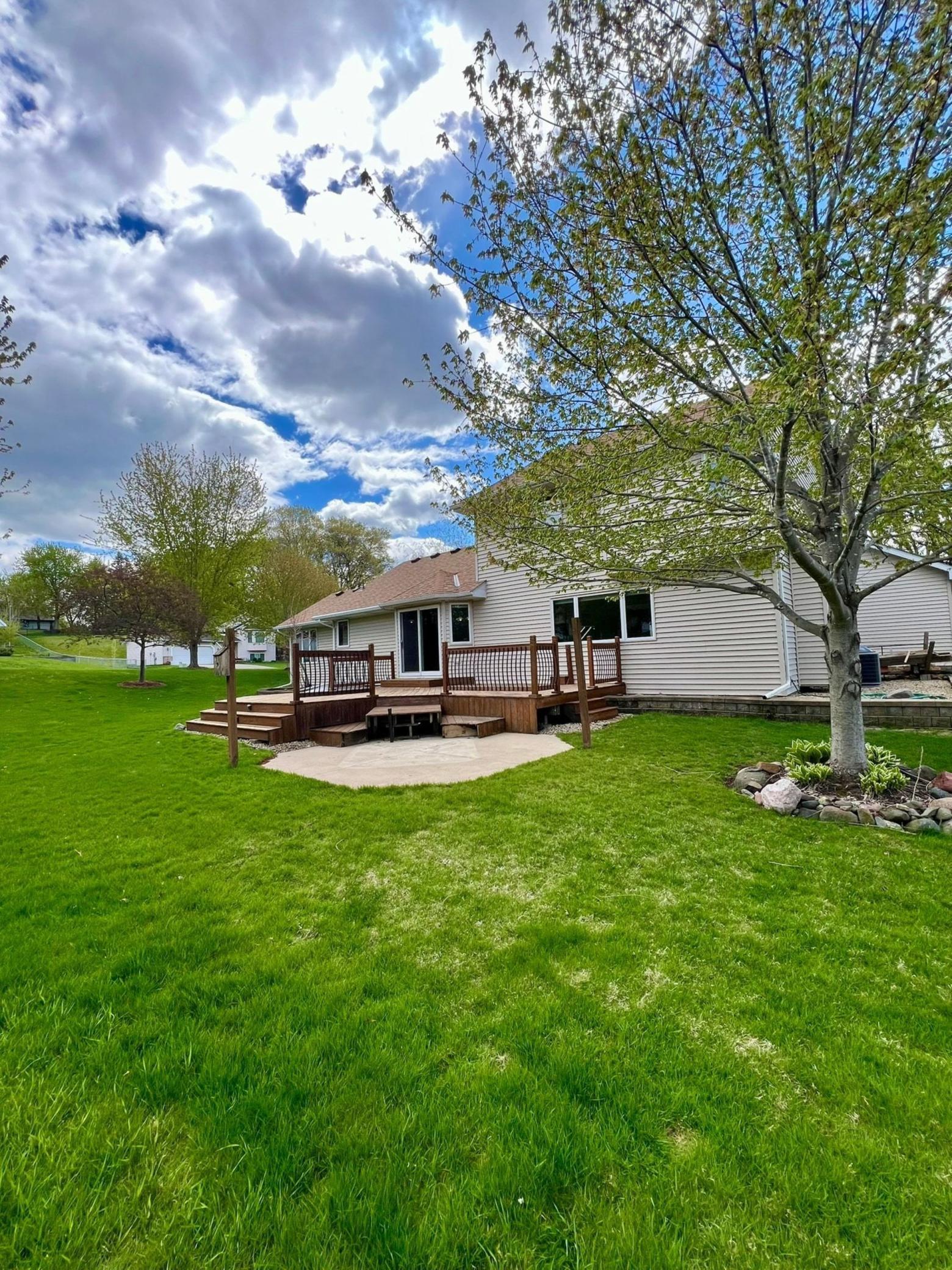 Another view of the backyard showcasing the deck and the patio pad with the 220v service.