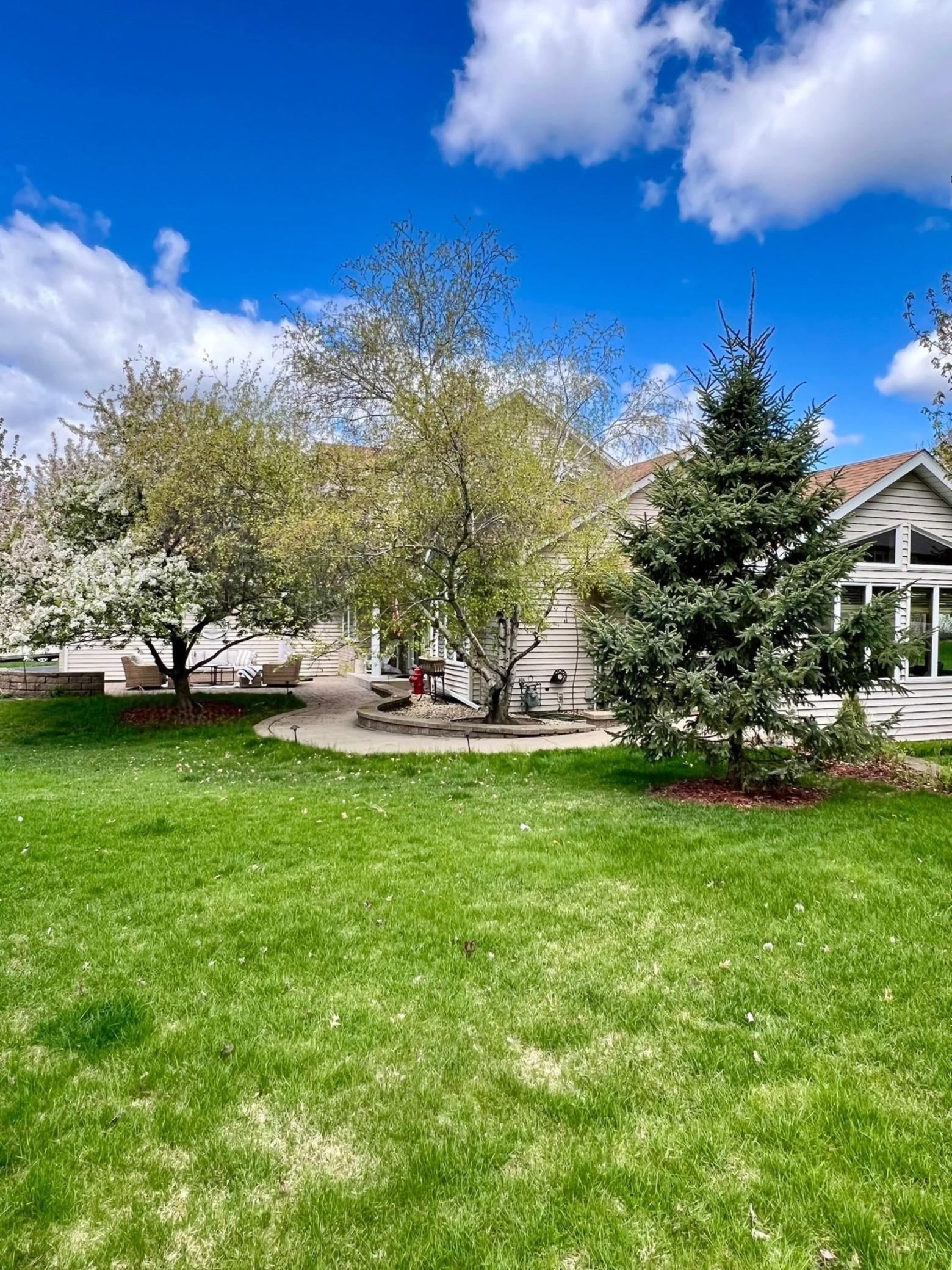 This view highlights the expansive corner lot. By being set back from both streets, the home offers an enhanced sense of privacy and a peaceful feel.