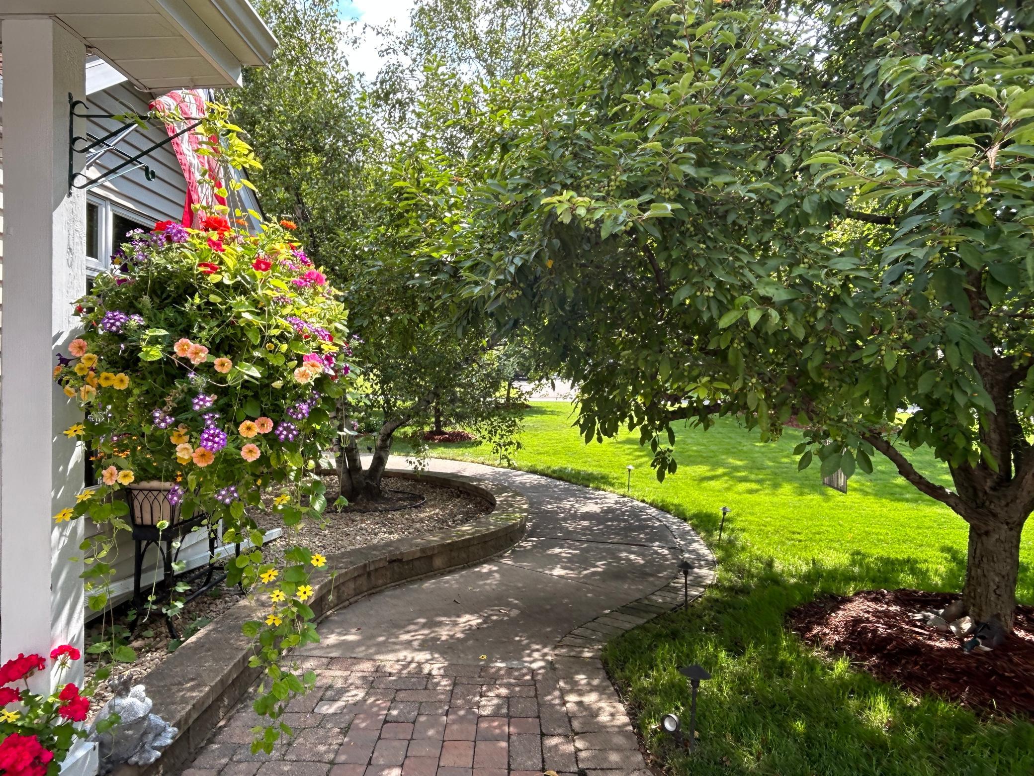 Summer view of the charming front walk to the private sunroom entrance.