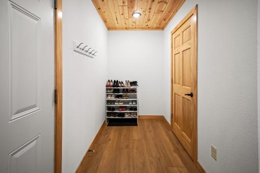 entrance from attached garage into mudroom area with closet