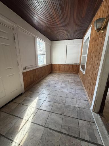 Versatile enclosed front porch offering significant bonus square footage.