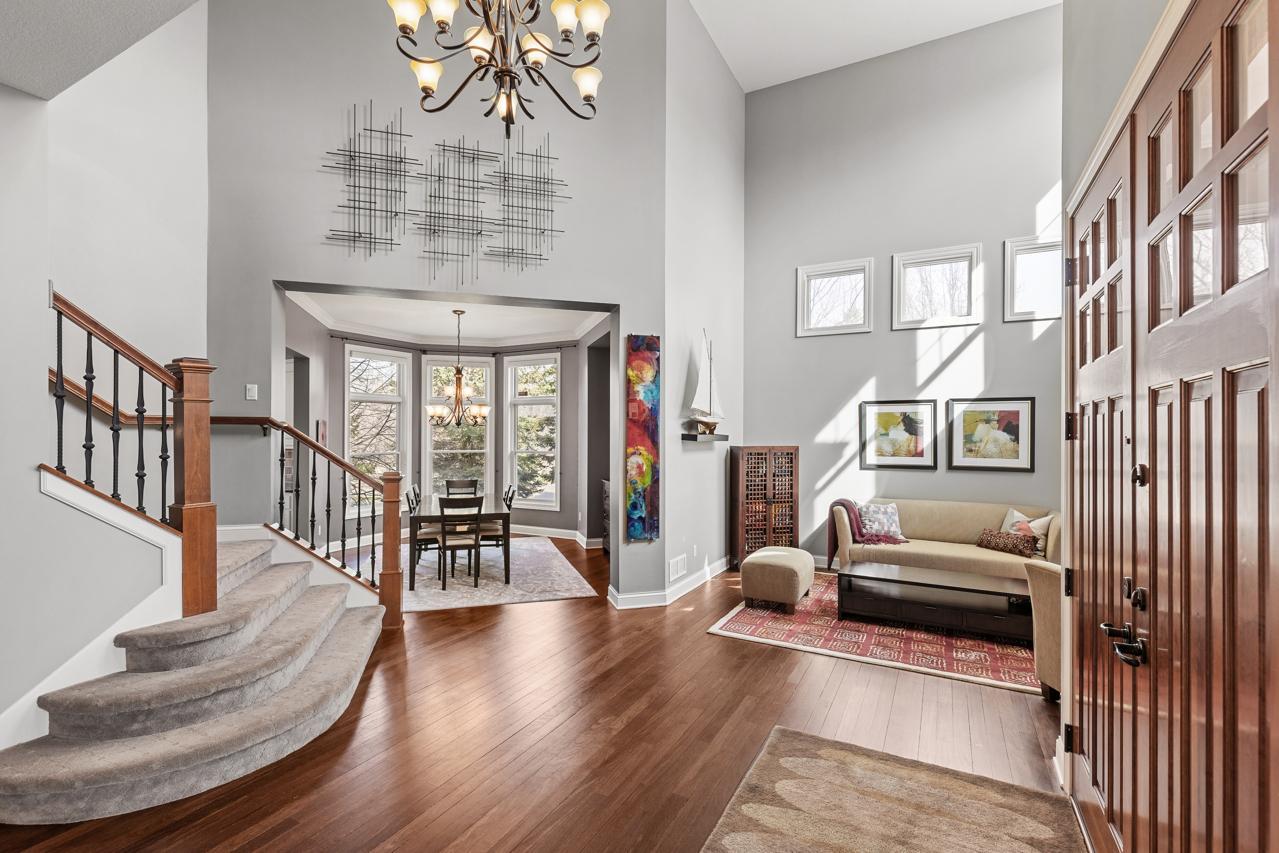 Grand two-story foyer with soaring ceilings and abundant natural light