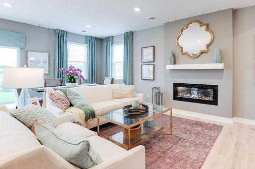 One of many highlights in the main level, the homes fireplace offers a touch of modernization of a space already loaded with a contemporary layout! Photo of previous model home, colors and finishes may vary.