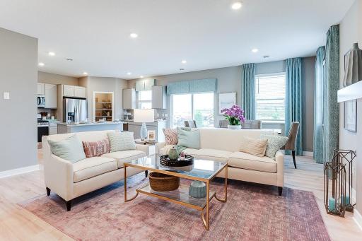 Open concept main living area with plenty of natural light throughout! Picture of previously built model home, finishes, selections, and colors will vary.