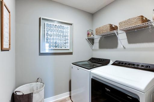 A nice size laundry room upstairs off of the bedrooms. Picture of previously built model home, finishes, selections, and colors will vary.