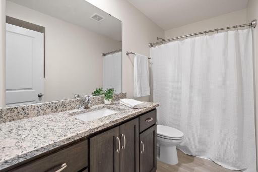 A full bathroom is located on the upper level near the second and third bedrooms.