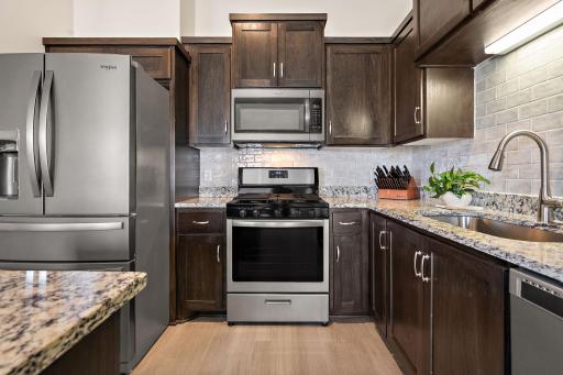 The kitchen has upgrades including stainless steel appliances and extra cabinetry beyond what the builder originally installed.