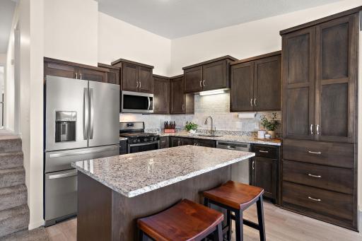 An upgraded refrigerator and tile backsplash make this kitchen stand out from builder grade new construction.