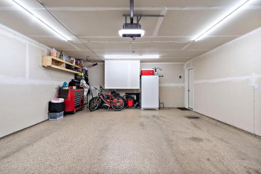 The garage is loaded with upgrades including epoxy floors, a top of the line insulated garage door, extra lights, and upgraded garage door opener.