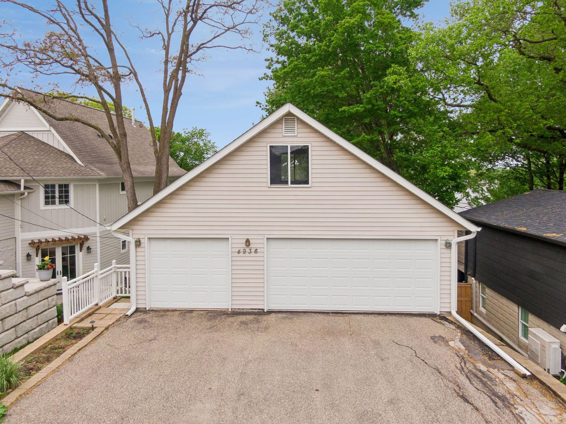 Three-car detached garage with additional lower-level storage for lake toys and gear.