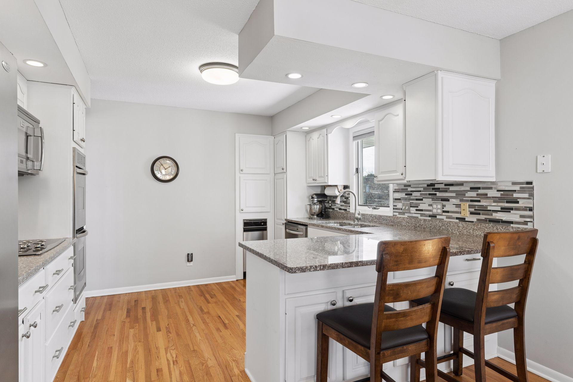 Granite countertops and excellent cabinet storage with pull out drawers.