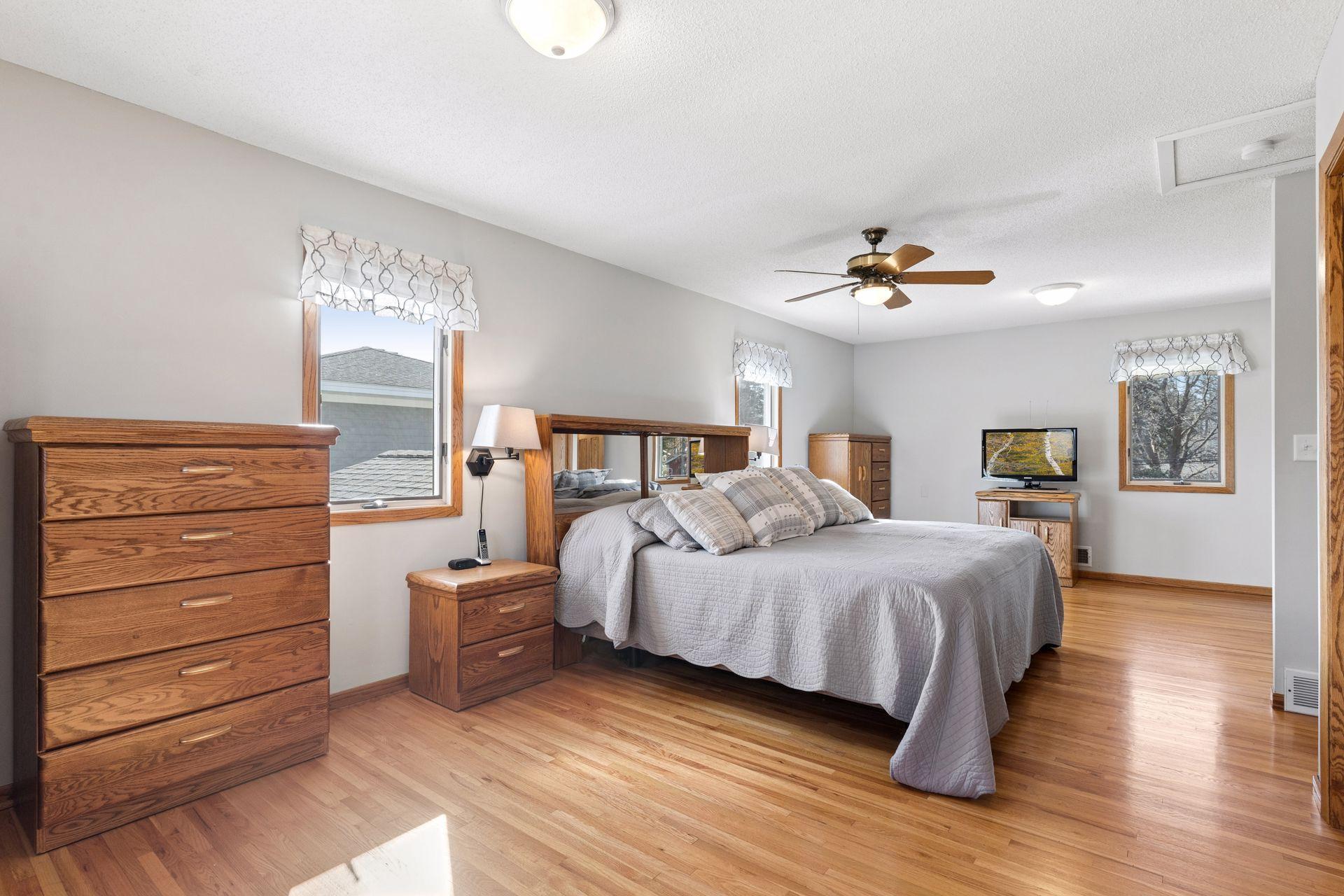 Expansive primary suite with hardwood floors, 3 closets and private 3/4 bath.