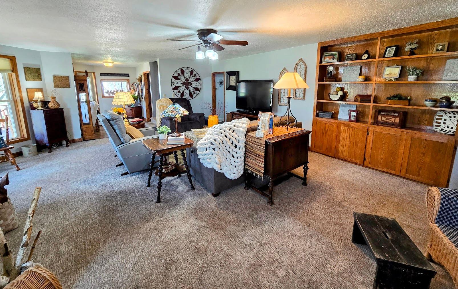 Open and spacious living room with built in bookcase & cabinets.
