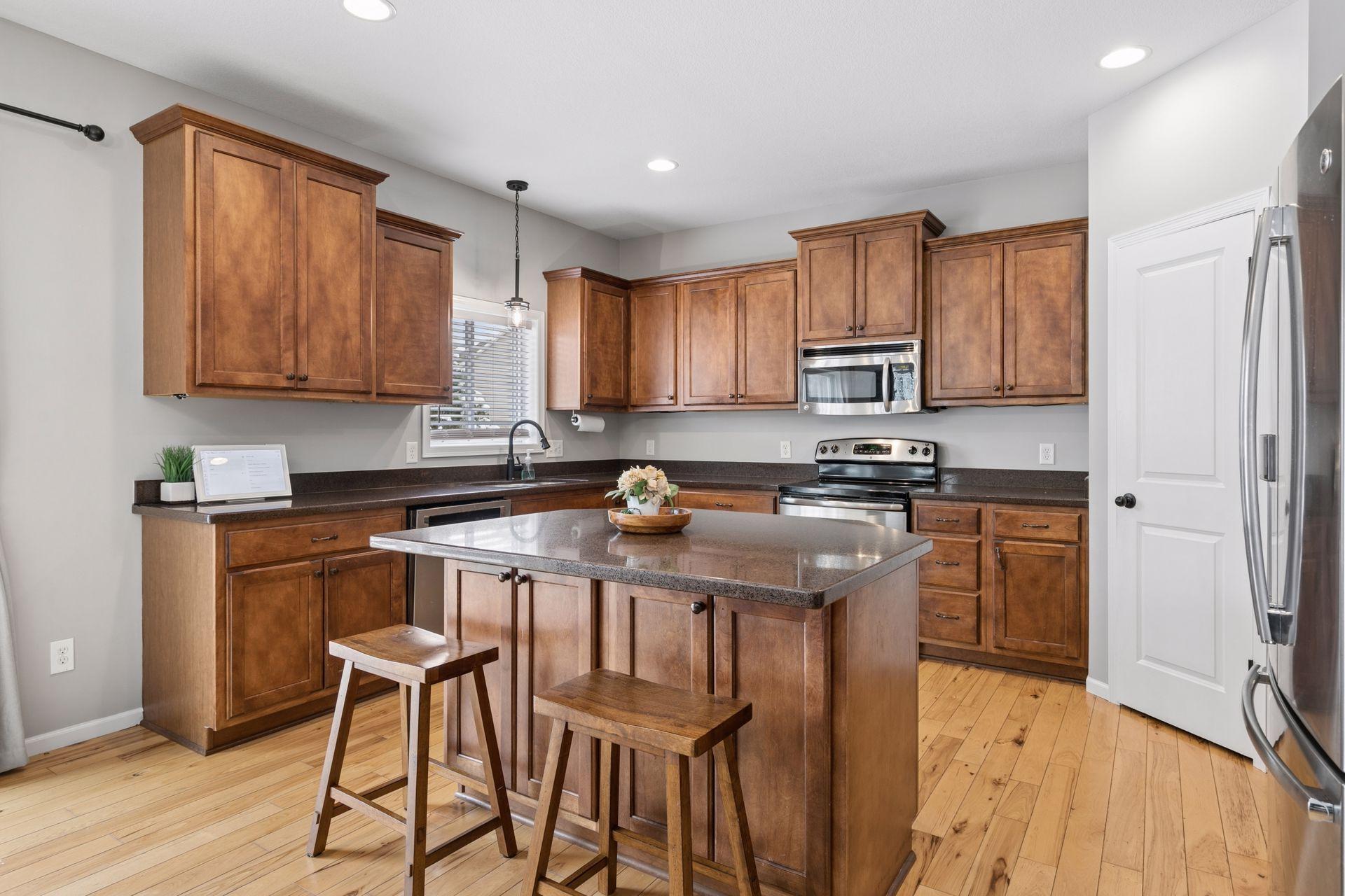 center island kitchen with SS appliances and Silestone countertops
