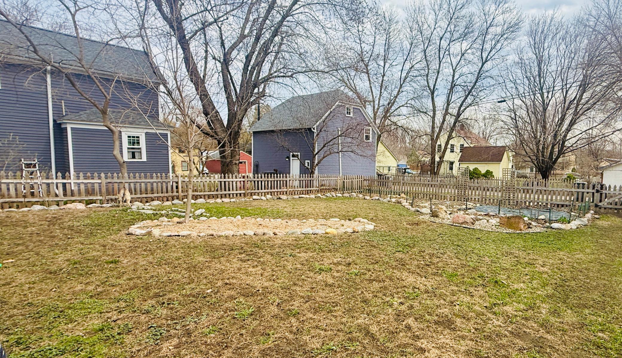 New landscaping includes a fire pit.