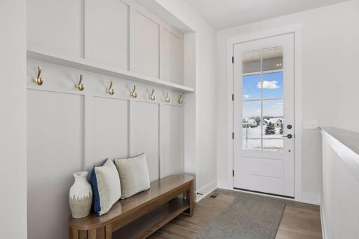 Inviting foyer with bench and hooks to hang your coat or purse