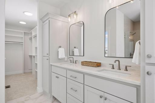 Private primary bathroom features dual sink vanity and custom built-ins