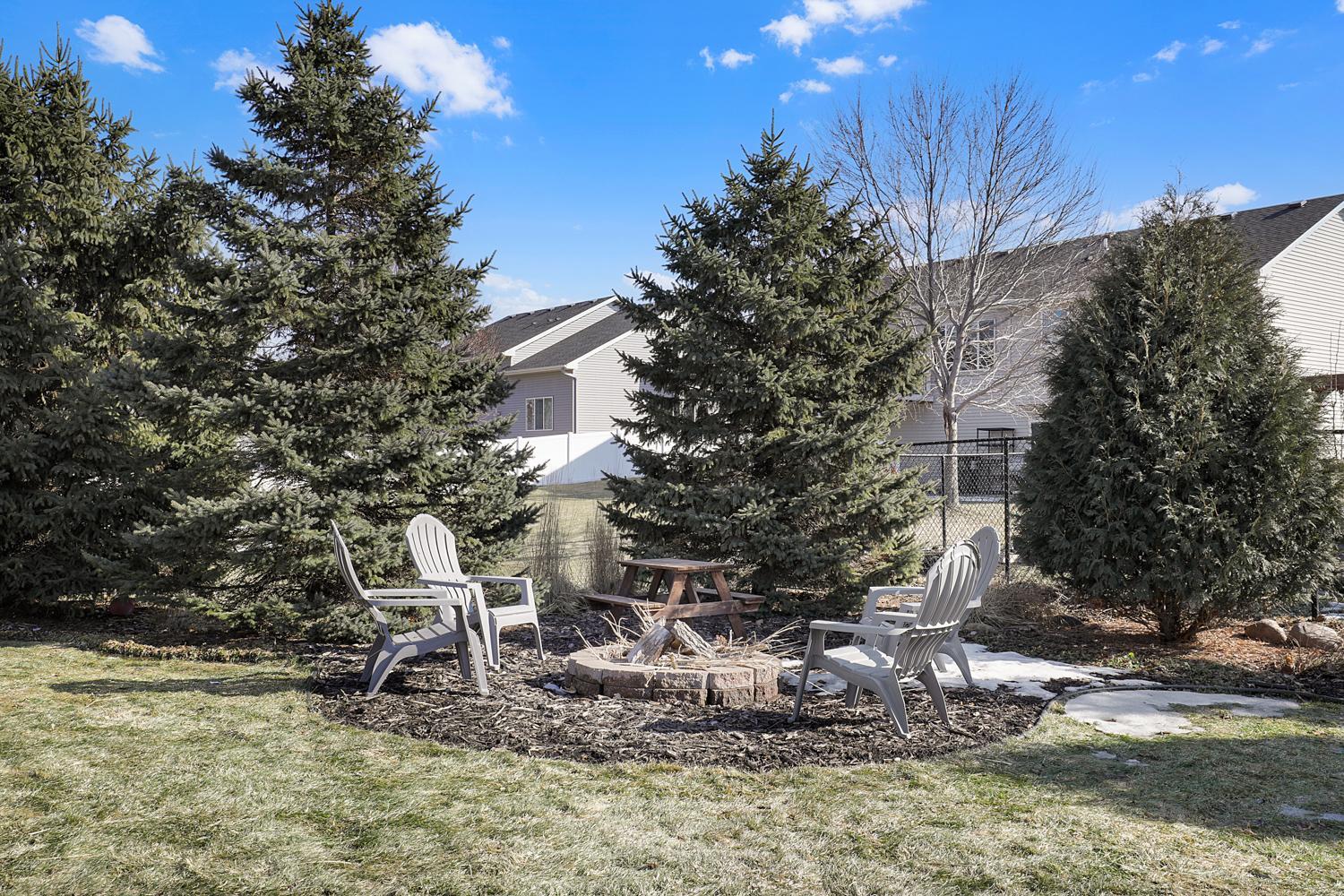 Fire pit and mature trees make a great space for community or evening fun