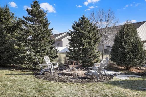 Fire pit and mature trees make a great space for community or evening fun