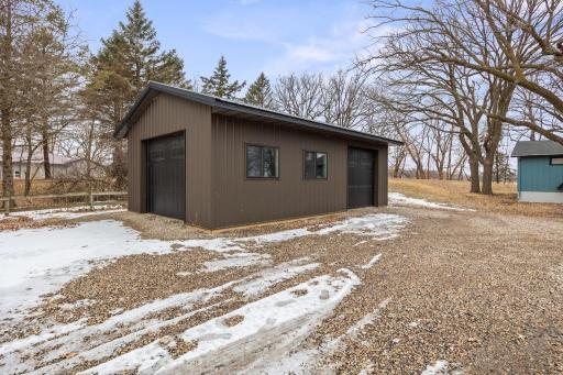Newly built shed with two garage doors and a service entry door