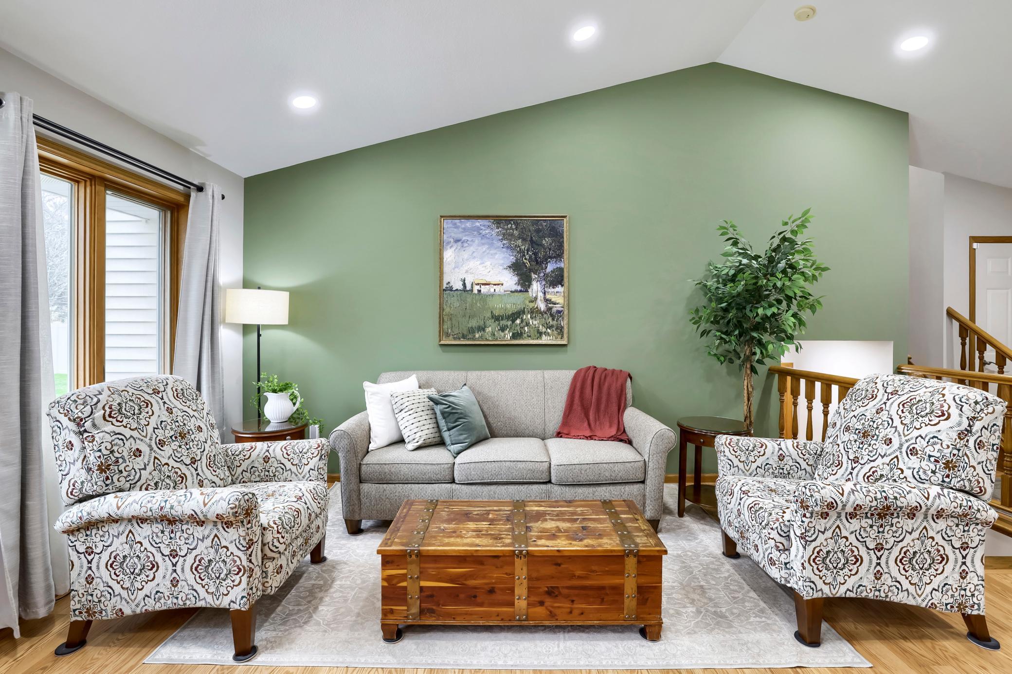 The vaulted ceiling with the can lighting supplement the large bank of windows to provide an open feel