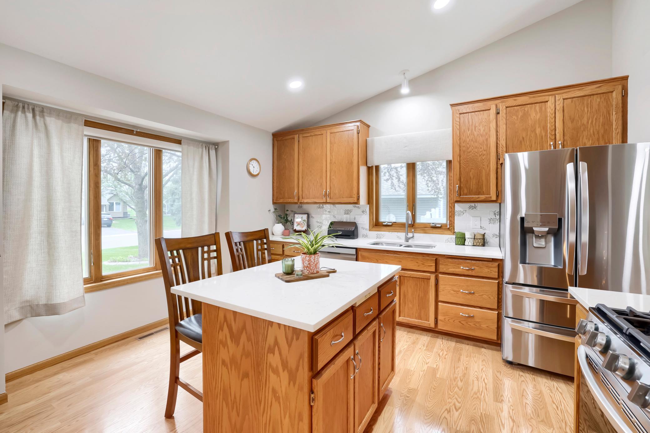 The recently redone kitchen features ample natural light from the south and west facing windows