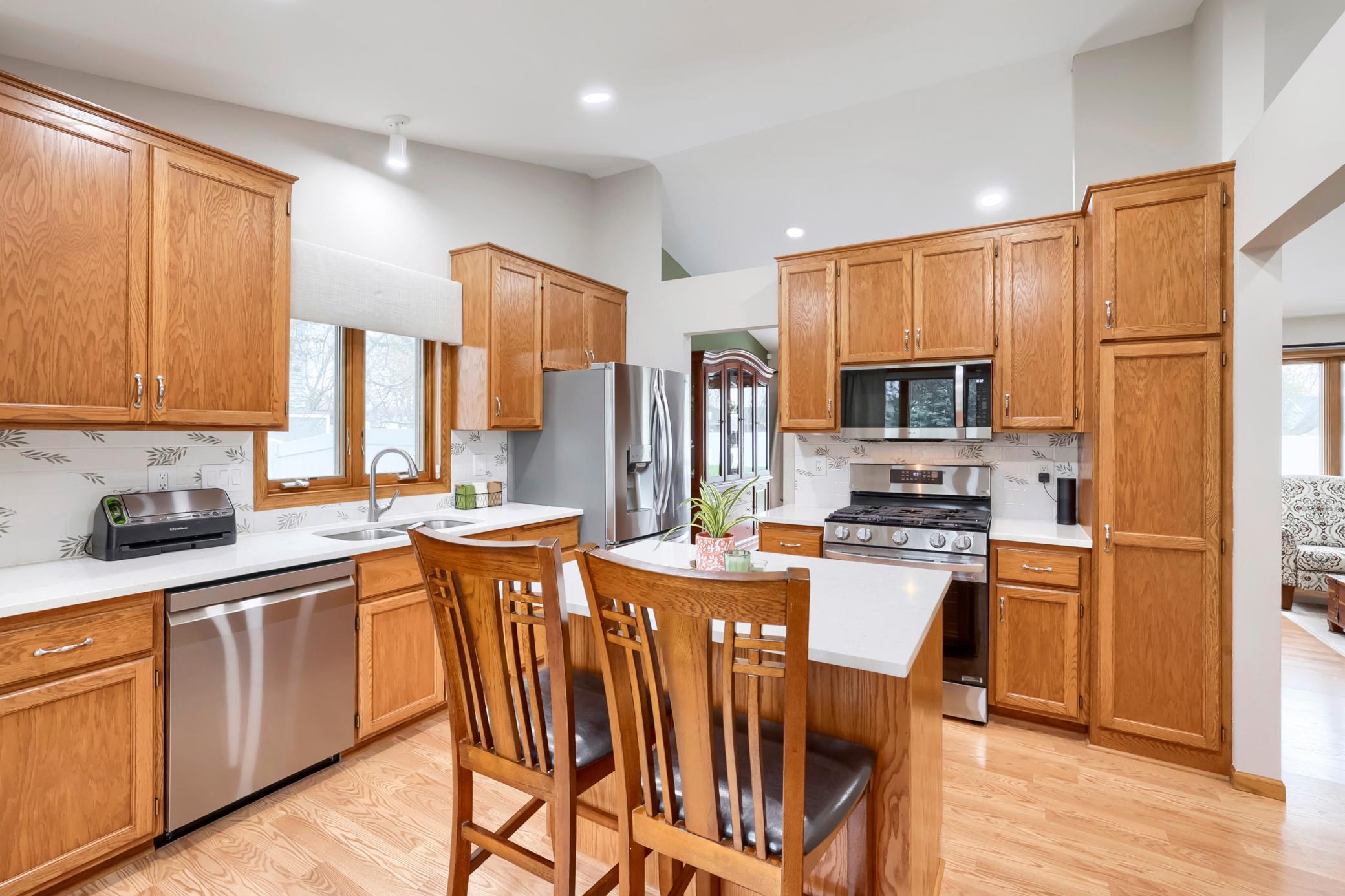 Newer stainless steel appliances, tile backsplashes and quartz countertops are highlights