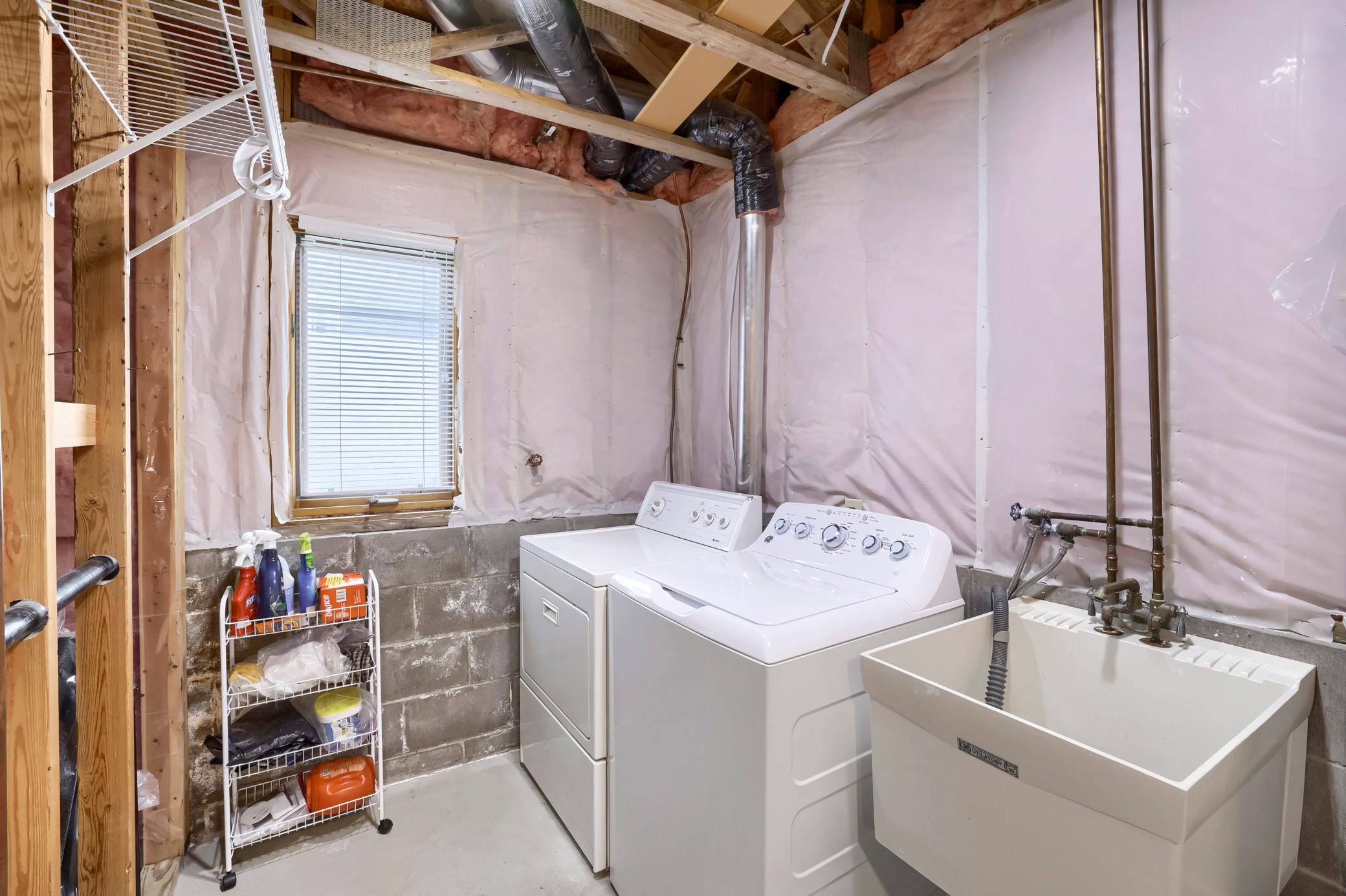 lower level laundry includes a good sized utility sink