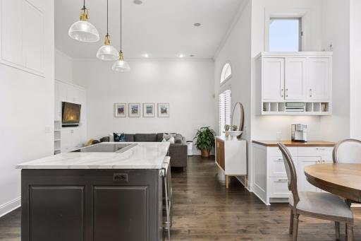 Open-concept main level with soaring ceilings, oversized windows, and a bright modern kitchen with center island. Perfect for everyday living and effortless entertaining.