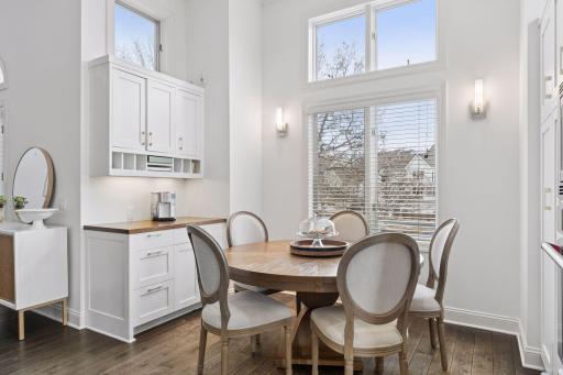 Sun-filled dining area with tall windows, built-in cabinetry, and easy access to the kitchen.